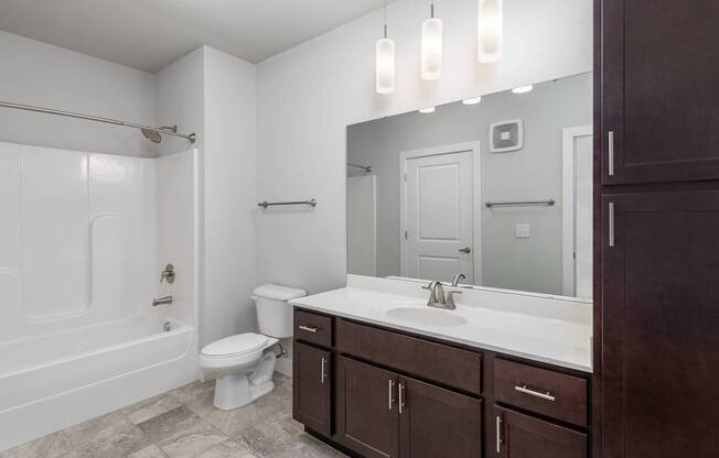 A bathroom with a white toilet, a white sink, and a white bathtub.