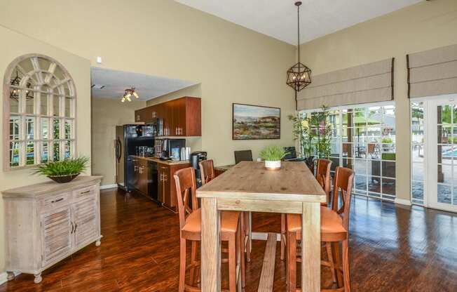 a dining room with a table and chairs and a kitchen