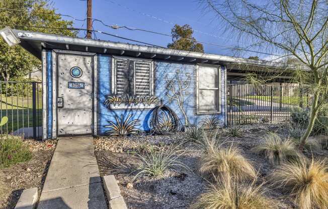 an old blue shack with graffiti on the side of it  at Sunset Ridge, San Antonio, TX, 78209