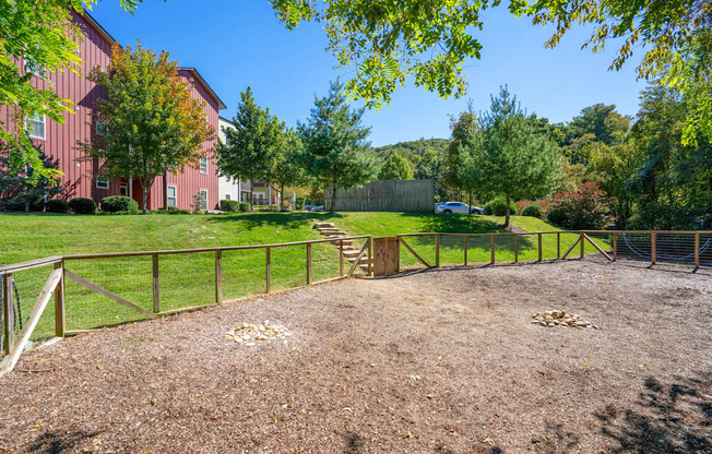 a fenced in area with trees and a fence at River Mill Lofts & Skyloft, Asheville, NC 28803