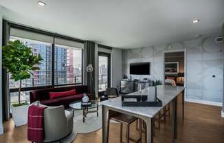 a living room and dining room with a table and chairs