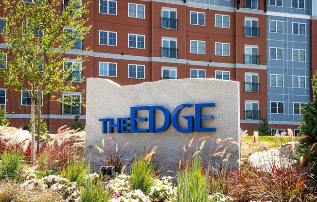 A sign that says "The Edge" in front of a building.