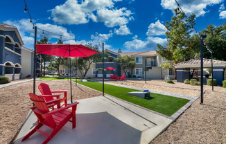 a red picnic table with a red umbrella and red chairs