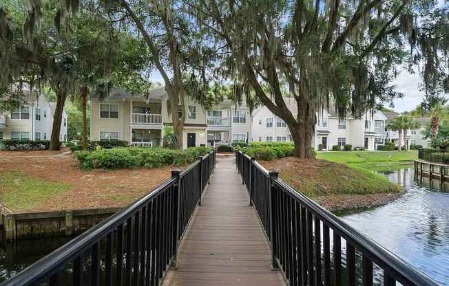 A wooden walkway leads to a row of houses.