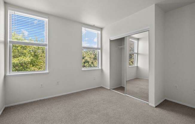 a bedroom with a mirror and a door to a closet