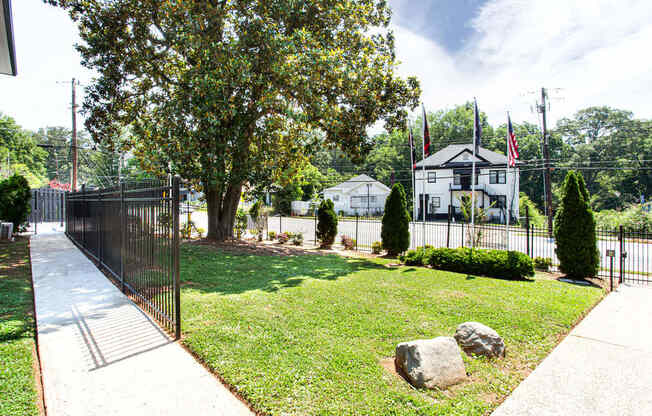 a yard with a tree and a black fence  at The Oasis on Cascade, Atlanta, GA, 30310