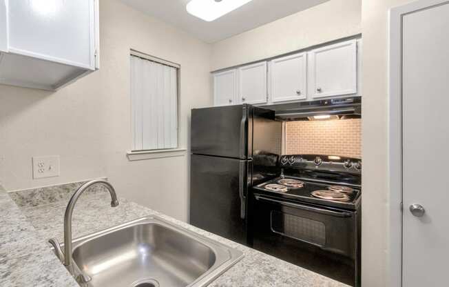 This is a photo of the kitchen in the 558 square foot 1 bedroom apartment at The Summit at Midtown Apartments in Dallas, TX.