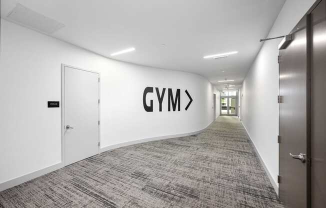 a view down a long corridor with a large logo on the wall