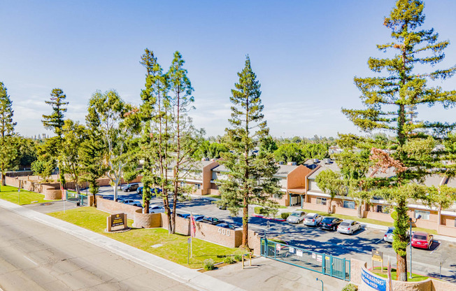 a view of a parking lot with trees and buildings