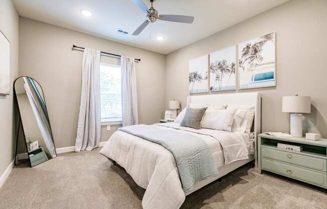 a bedroom with a bed and a ceiling fan