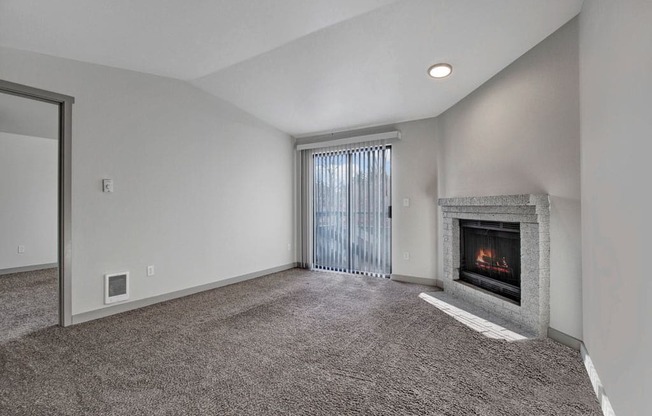 a living room with a fireplace and a sliding glass door