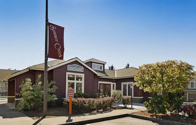 an exterior view of a red building with a flag on a pole