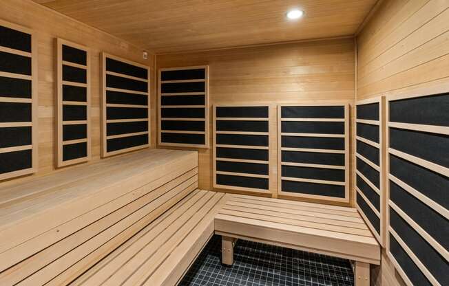 a sauna with a bench and a wall of closets