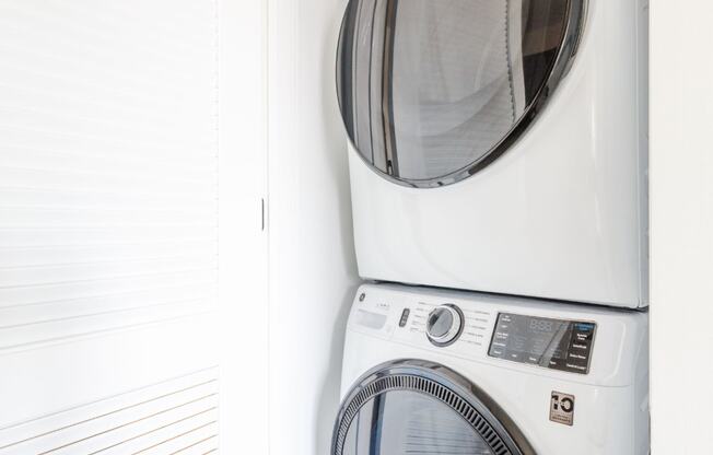 a white washer and dryer in a laundry room at Dey & Bergen, Harrison, 07029