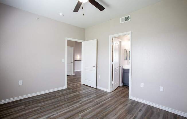 A room with a ceiling fan and light fixture.