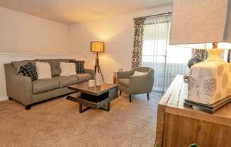 a living room with a couch and two chairs