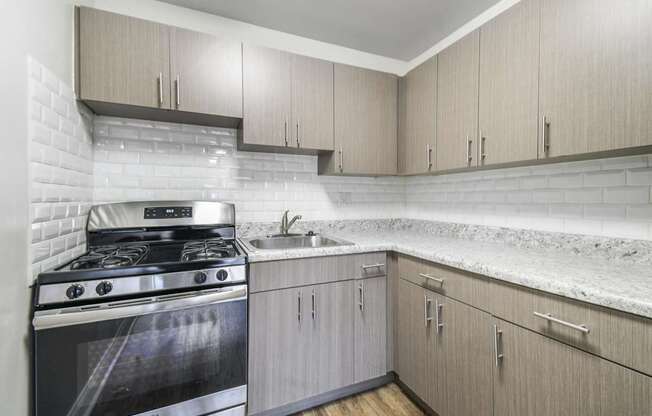 A modern kitchen with a stove and cabinets.