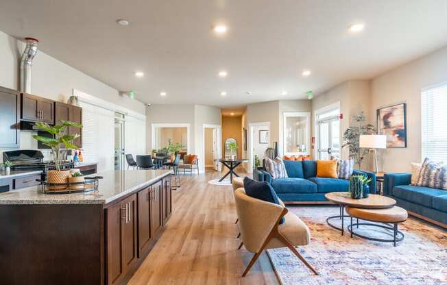 image of the clubhouse with a kitchen and a blue couch and island