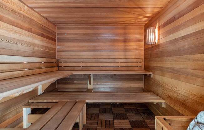 a wooden sauna with benches on the floor