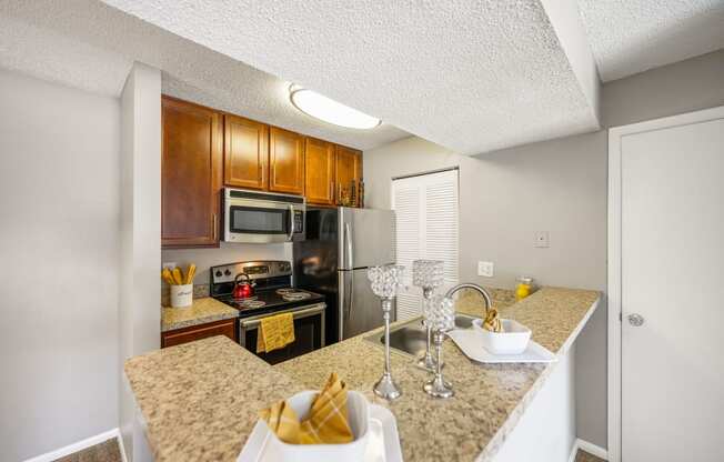 a kitchen with granite counter tops and stainless steel appliances