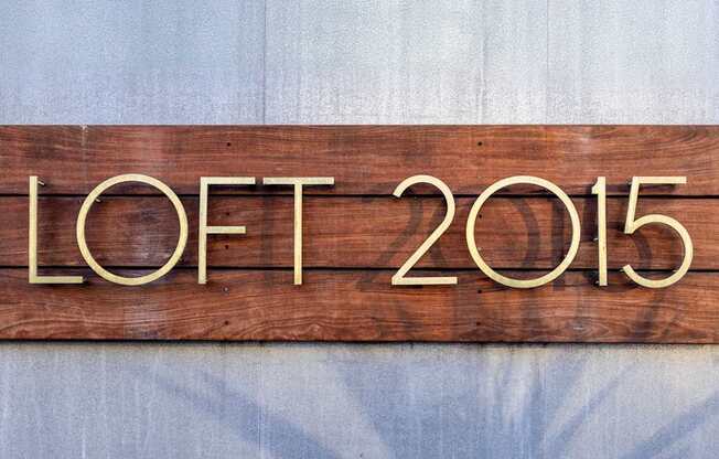 A wooden sign with the letters "LOFT 2015" is displayed.