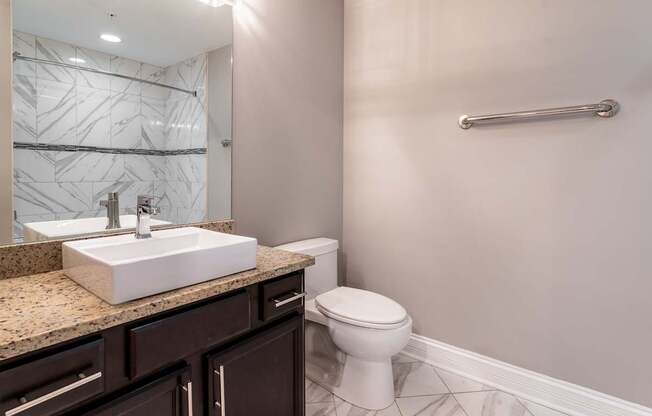 a bathroom with a toilet and a sink and a mirror