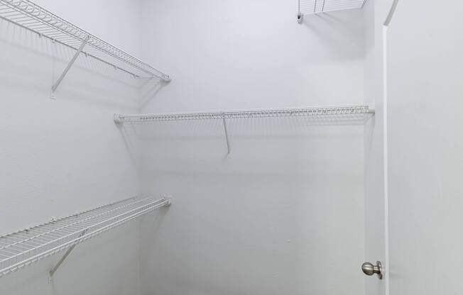Empty white shelves in a room.