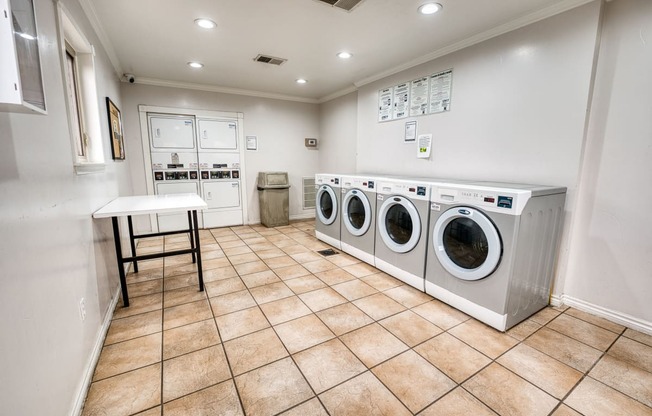 a washer and dryer in a laundry room with a table