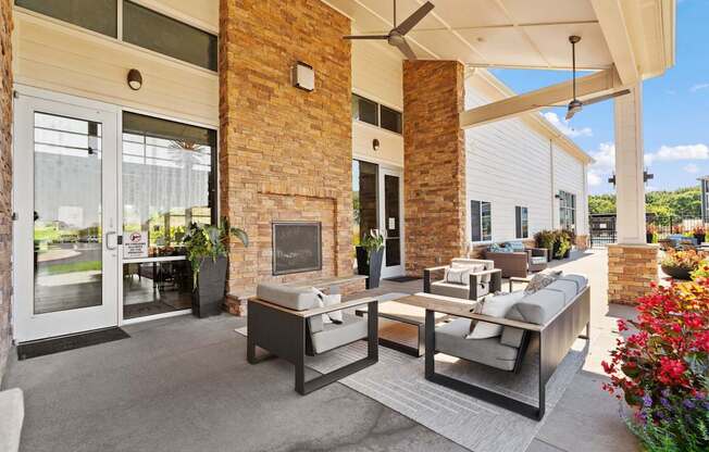 A patio with a table and chairs is covered by a roof.