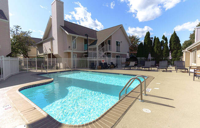 a pool with a house in the background