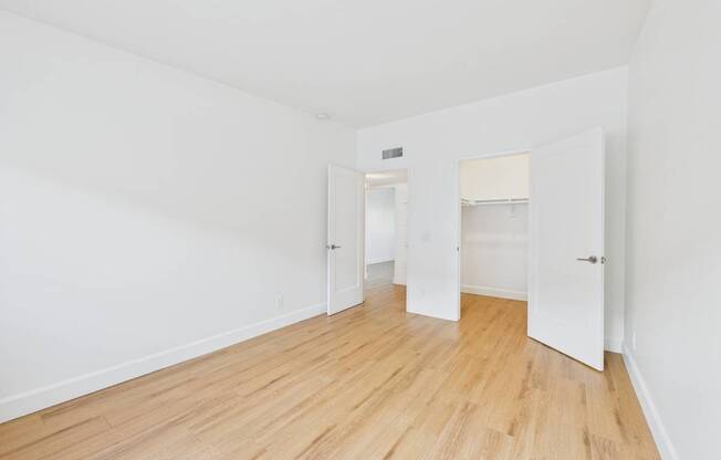 A room with wooden floors and white walls.