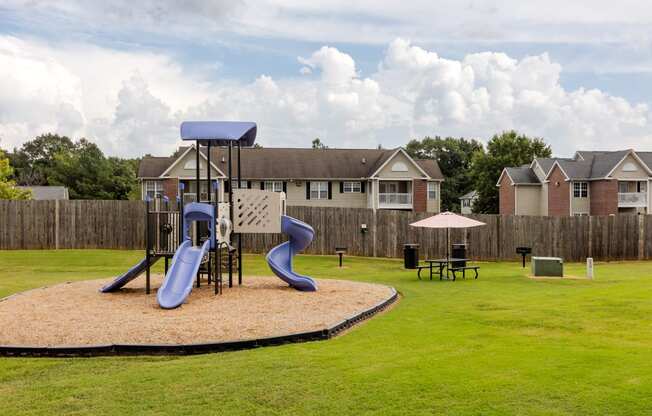 our apartments have a playground with slides and a picnic table