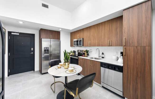 a kitchen with wooden cabinets and stainless steel appliances