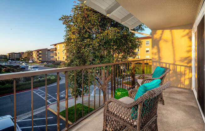 a balcony with a swing and a view of the city