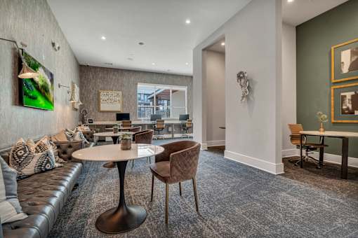 A modern living room with a grey carpet and a white table.