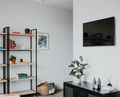 a living room filled with furniture and a flat screen tv
