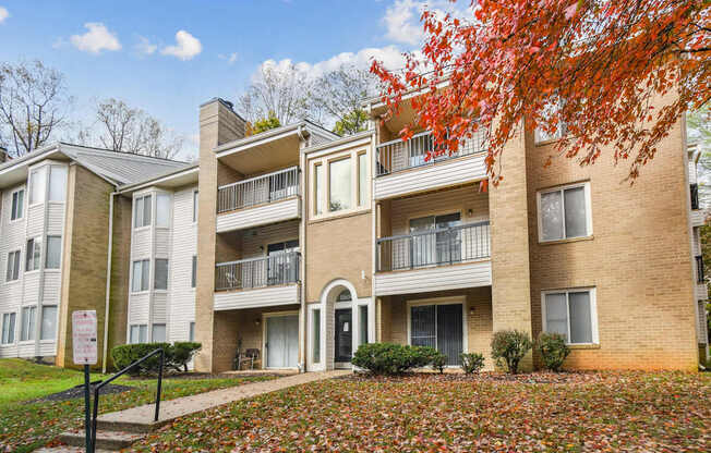 Apartment building with a sign in front of it.