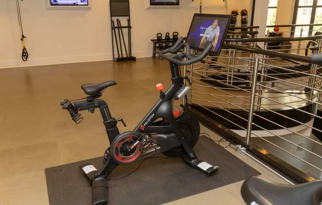 a stationary bike in a gym with a screen on it