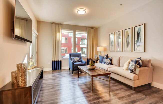 A living room with a blue chair and a beige couch.