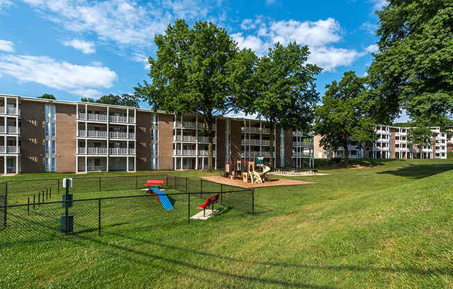 a dog park in front of an apartment building