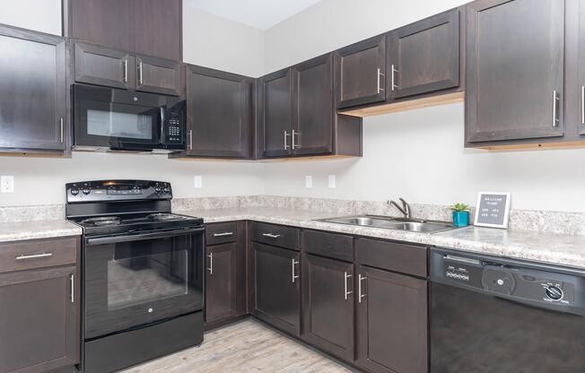 a kitchen with stainless steel appliances and wooden cabinets