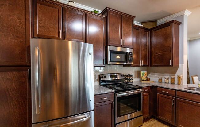 a kitchen with stainless steel appliances and wooden cabinets