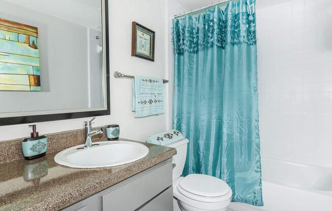 a shower curtain next to a sink