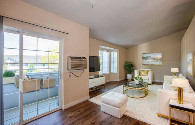 a living room with a door to a balcony