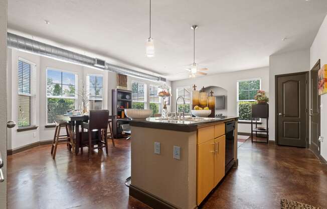 a kitchen with a large island in the middle of a living room