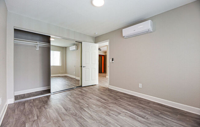 an empty living room and hallway with a door to a closet at Citra Apartments LLC, San Diego