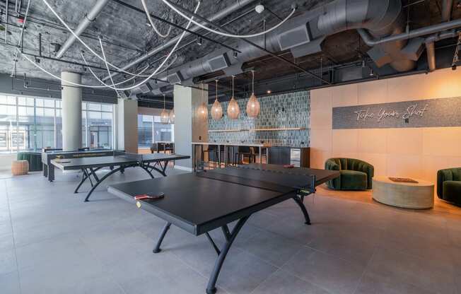 a games room with ping pong tables and other gaming equipment