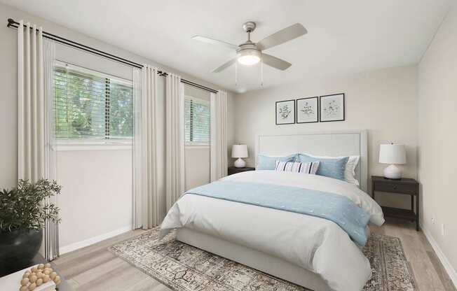 a bedroom with a bed and a ceiling fan