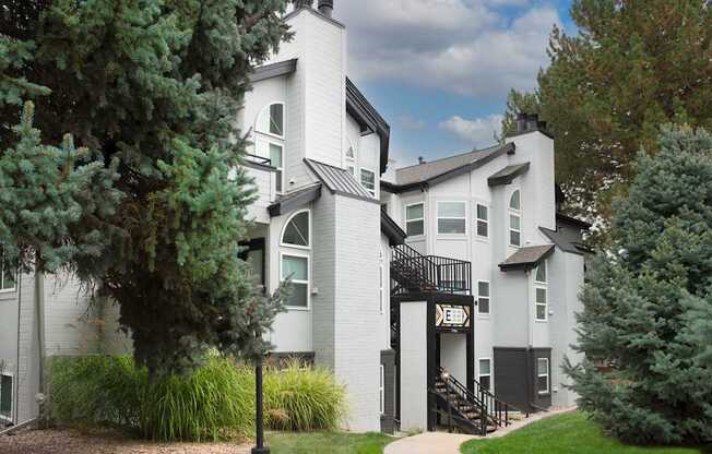 A white house with a black staircase.