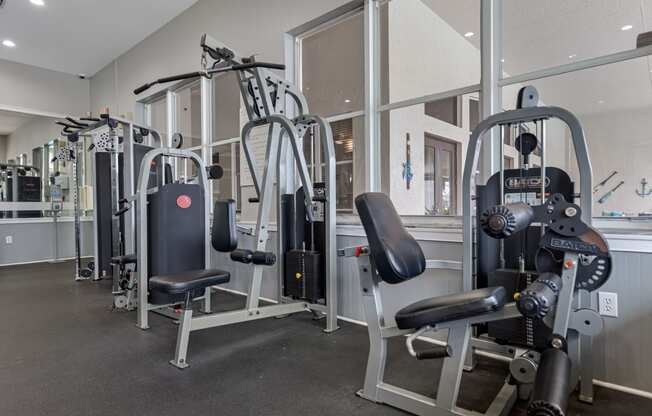 a gym with weights and cardio equipment in a building